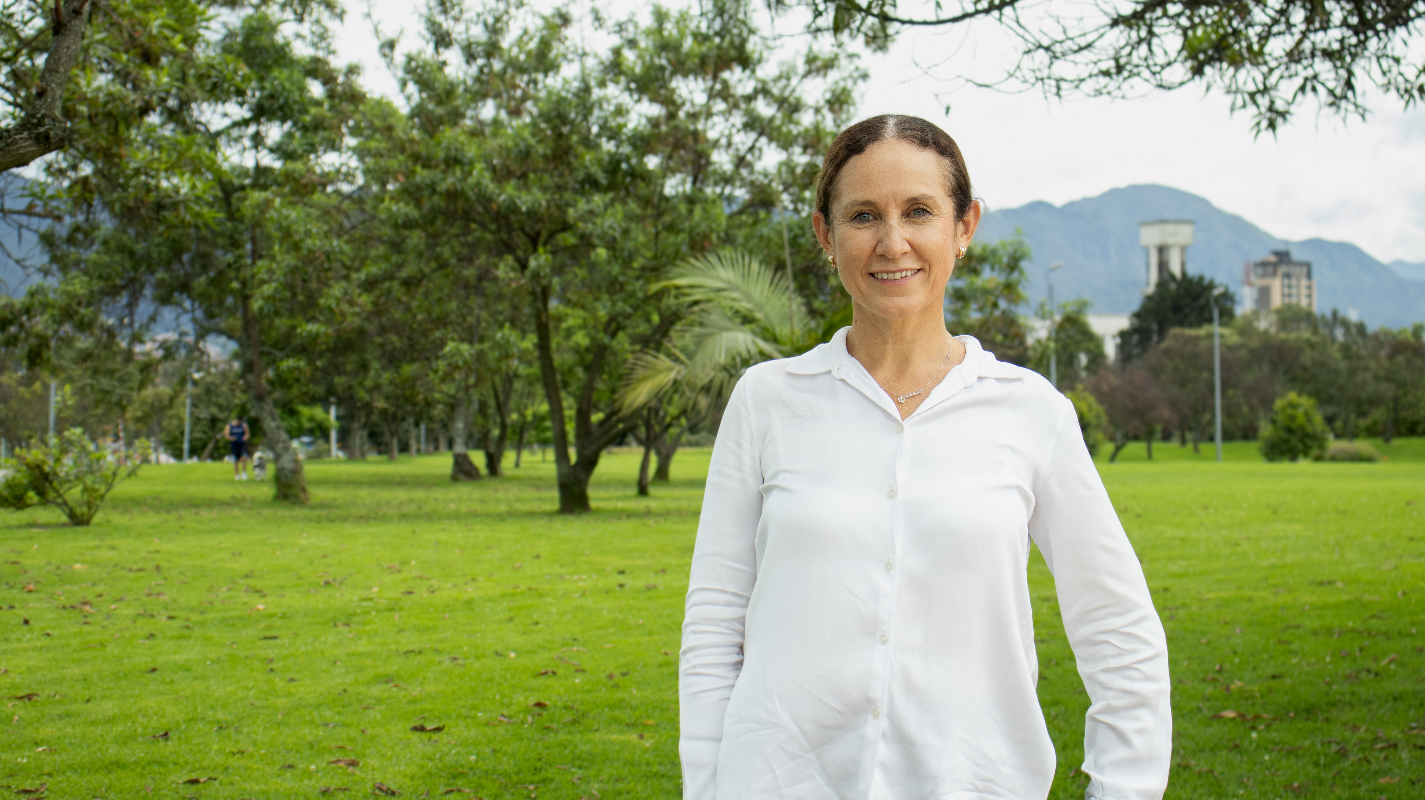 Cecilia Vaca Jones, Executive Director of Breathe Cities, standing outdoors in a park setting.